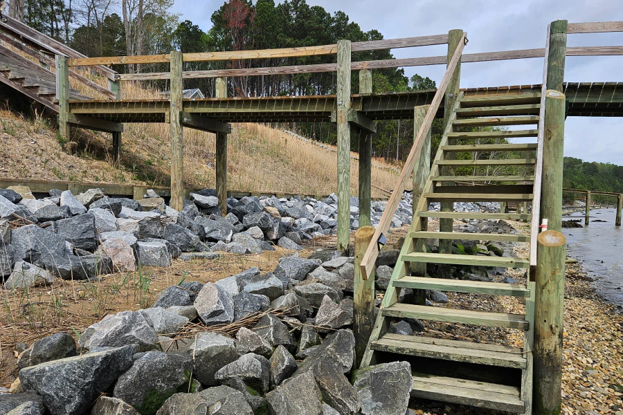 wooden dock and stairs under rocks